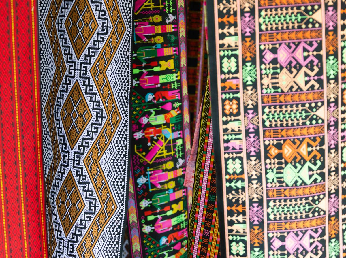 Custom fabric printing nearby showing vibrant cotton samples with crisp logo detail on a studio table